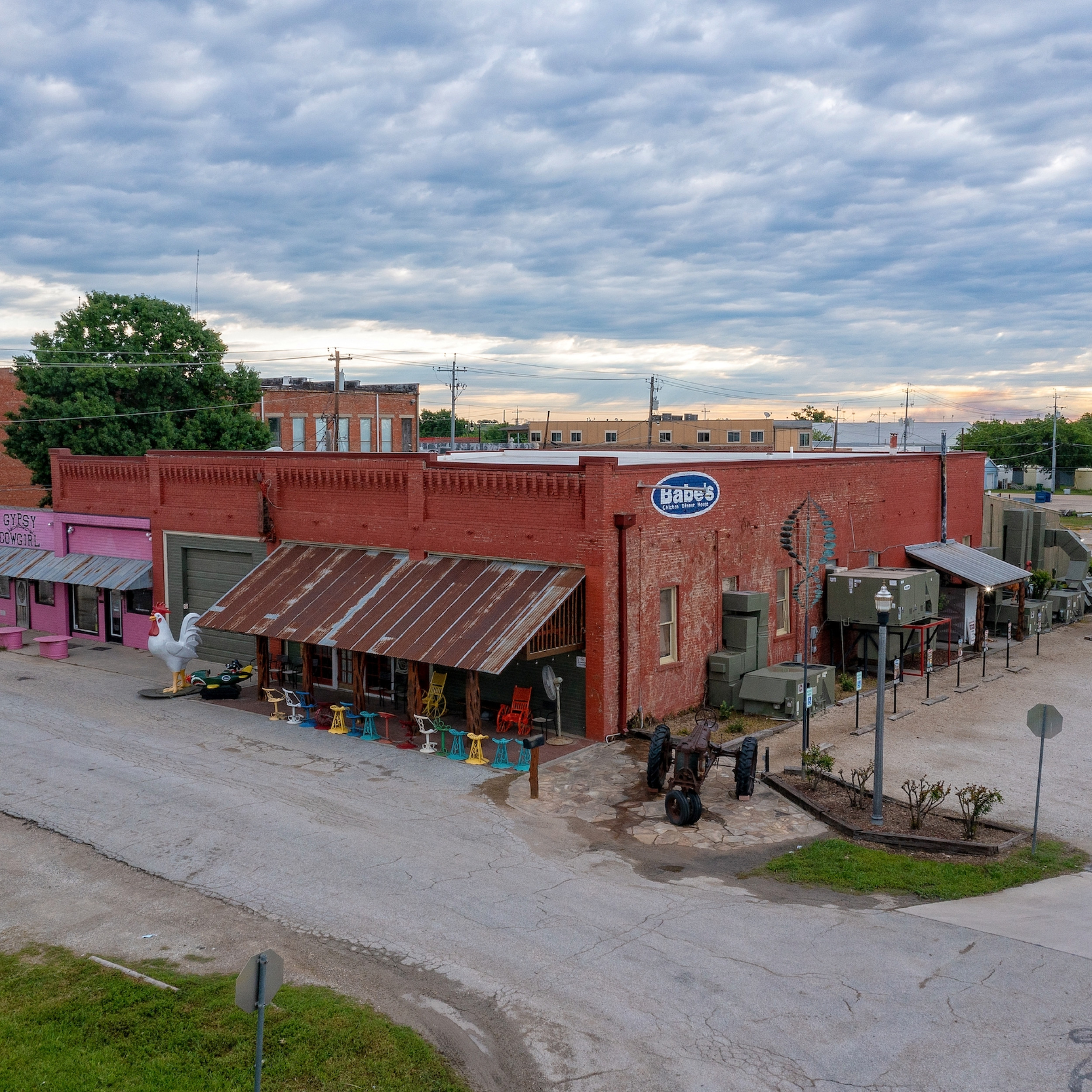 aerial view of babe's chicken dinner and gyspy cowgirl with sanger downtown in the background